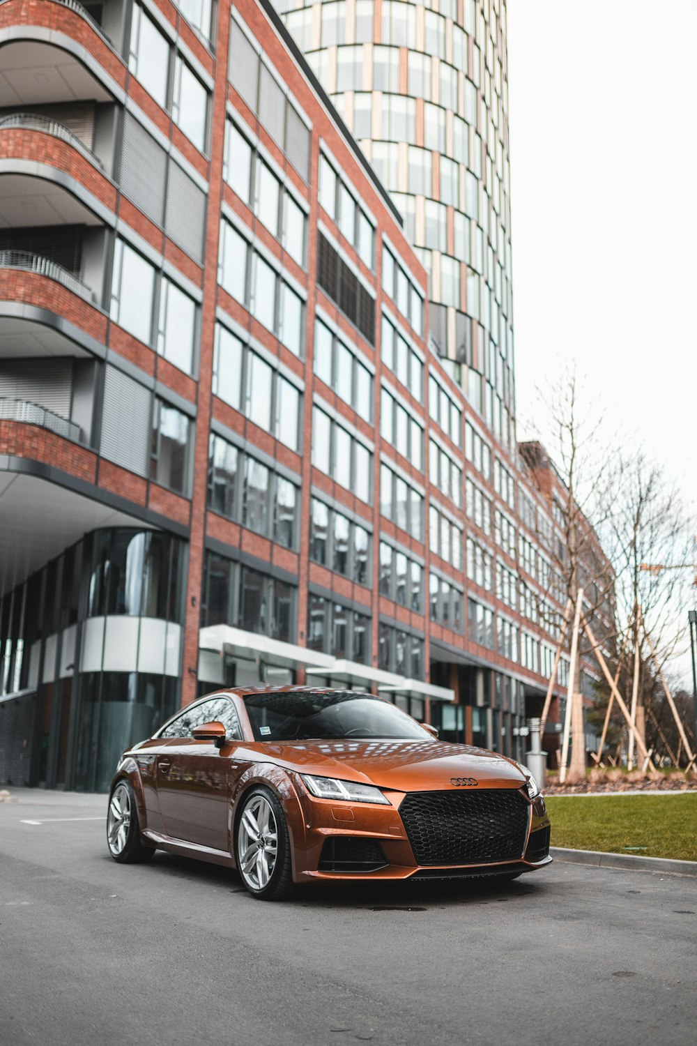 brown Audi TT parked in front of building