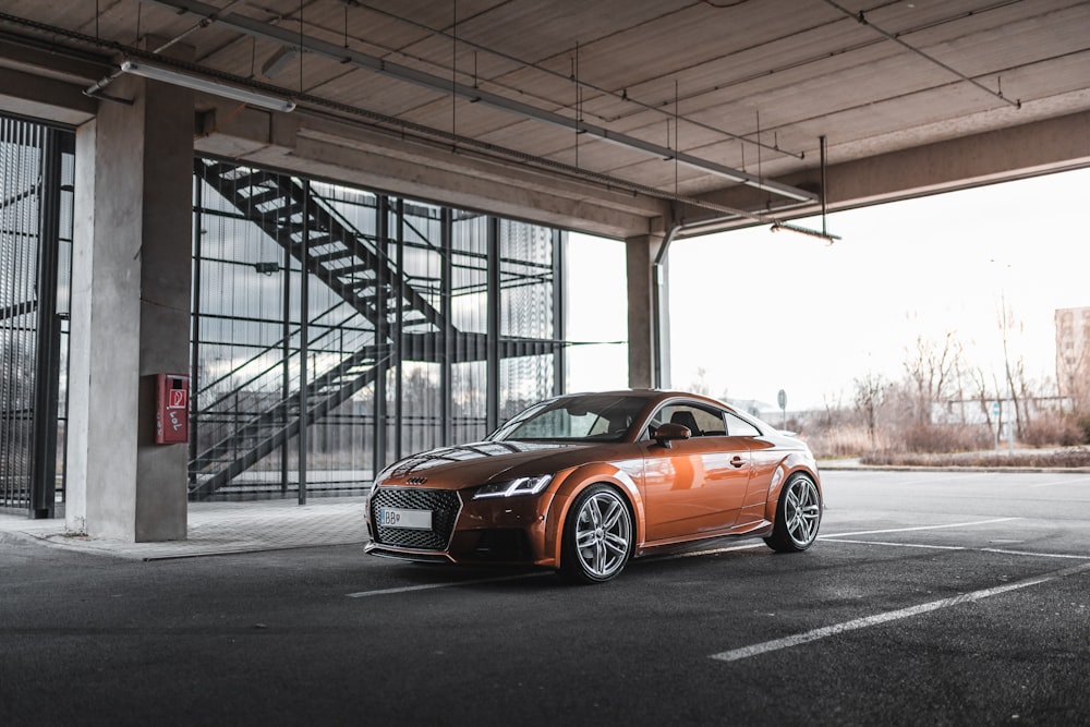 brown Audi TT parked inside lot