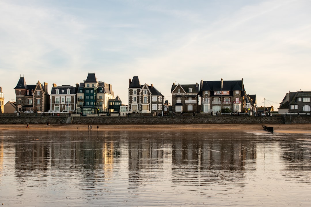 line of buildings and body of water during day