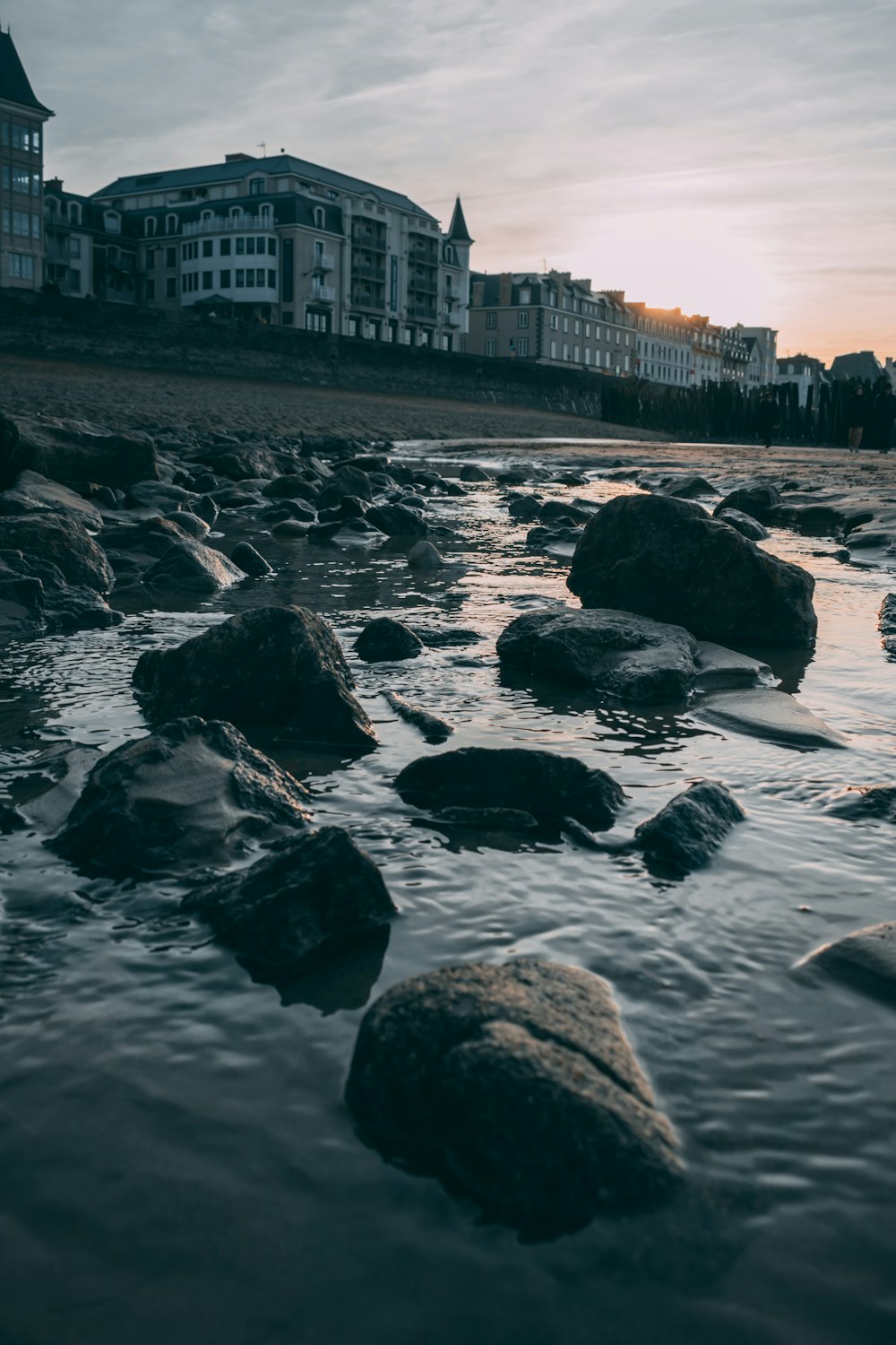 stones on body of water during daytime