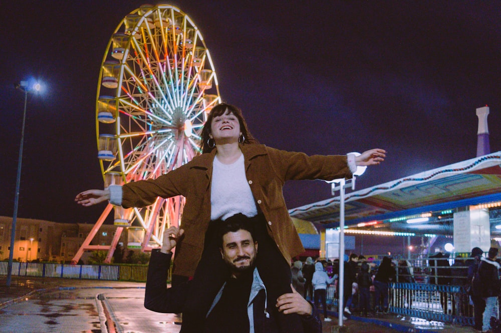 shallow focus photo of man carrying woman in brown button-up jacket