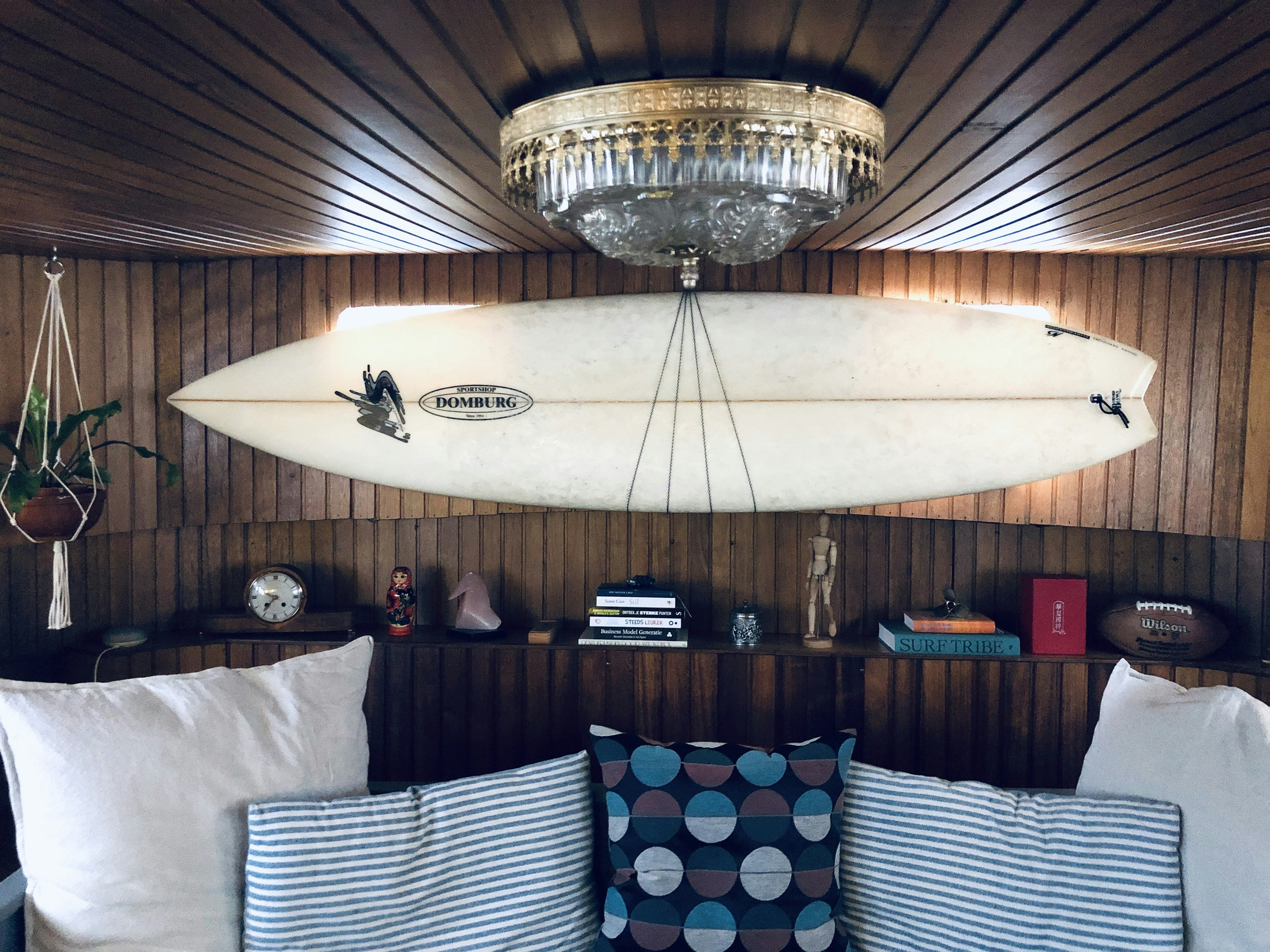 White And Black Surfboard Mounted On Wall Photo Free