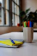 A neatly arranged desk with colorful pens, notebooks, and sticky notes.