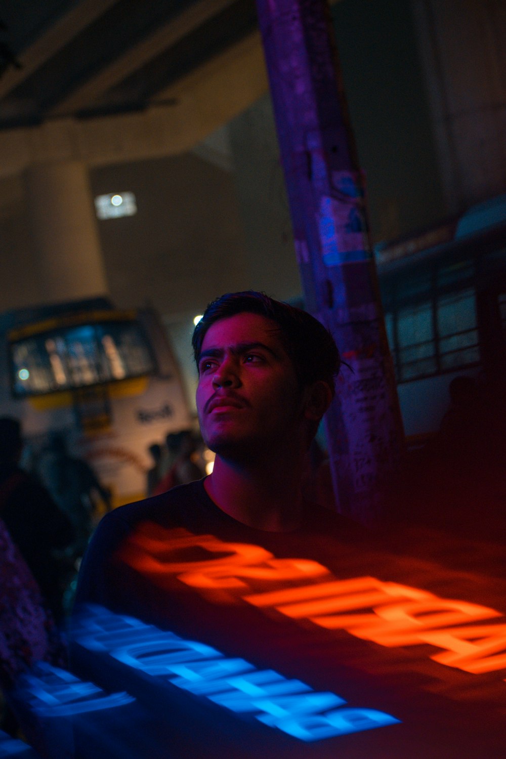 man near a neon light signage