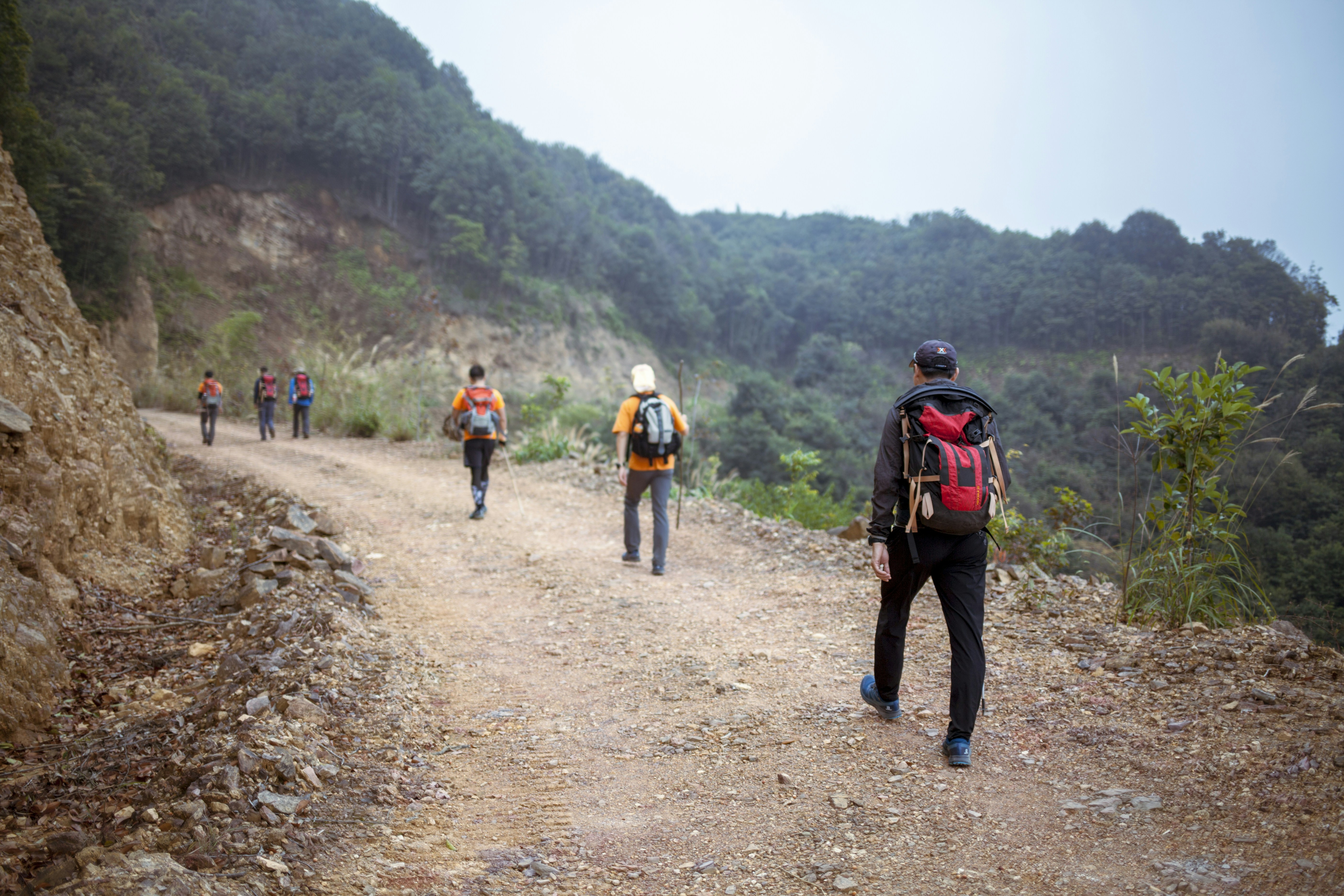 men hiking in the mountain during daytime