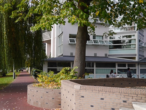 A friendly maintenance technician speaking with a government building manager outside a municipal office.