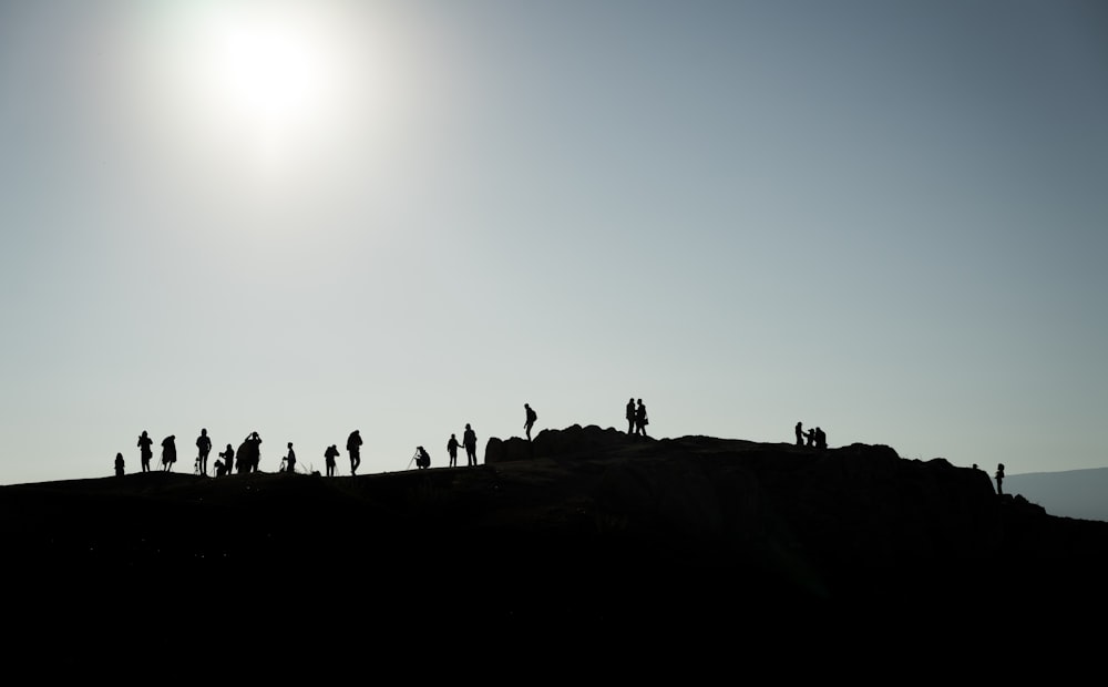 silhouette of people on mountain