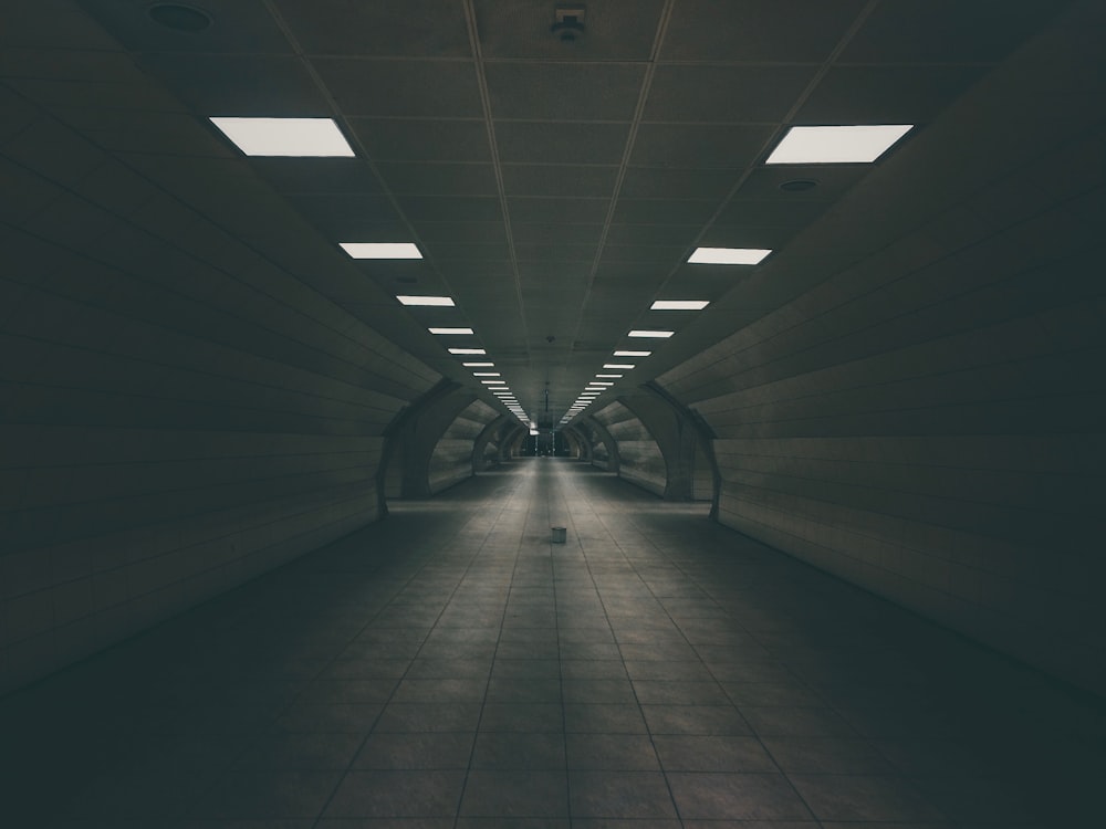 dark tunnel road with turned on ceiling lamps