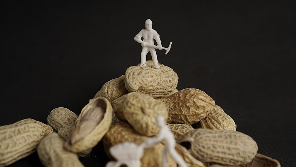 miner minifigure on top of a pile of brown peanuts