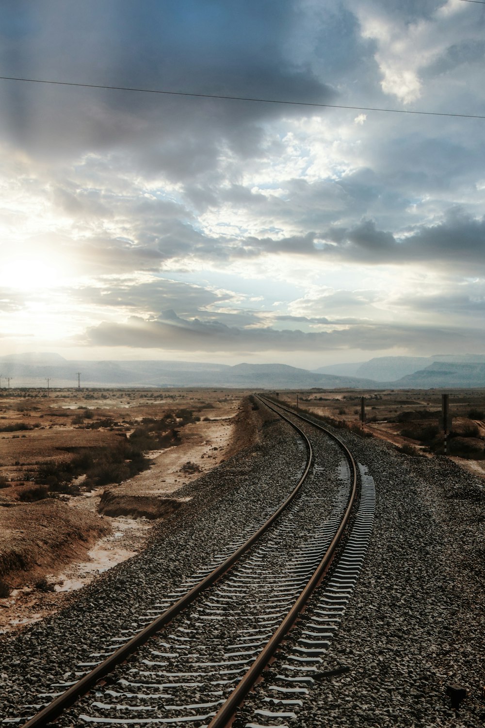 train railroad under a cloudy sky