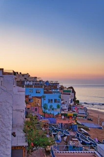 A serene coastal town with colorful houses and clear blue waters, perfect for digital nomads seeking inspiration.