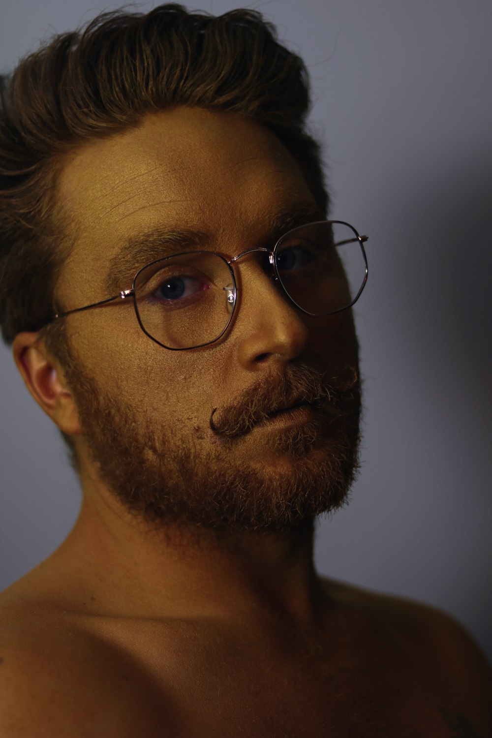 shallow focus photo of man wearing eyeglasses