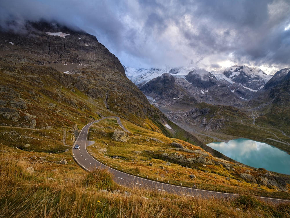 road on grass field and mountains during day