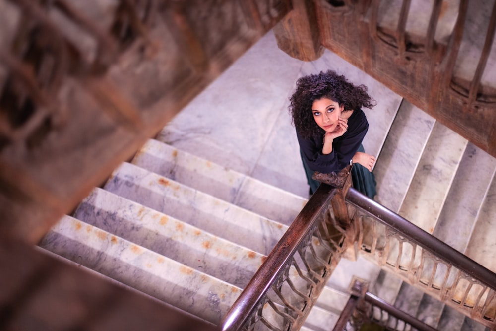 shallow focus photo of woman standing on stairs