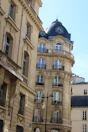 View from hotel room balcony showing historic European architecture and cobblestone streets.