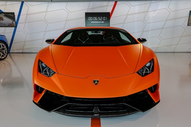 A modern orange-themed online car store homepage showing featured cars and easy installment options.