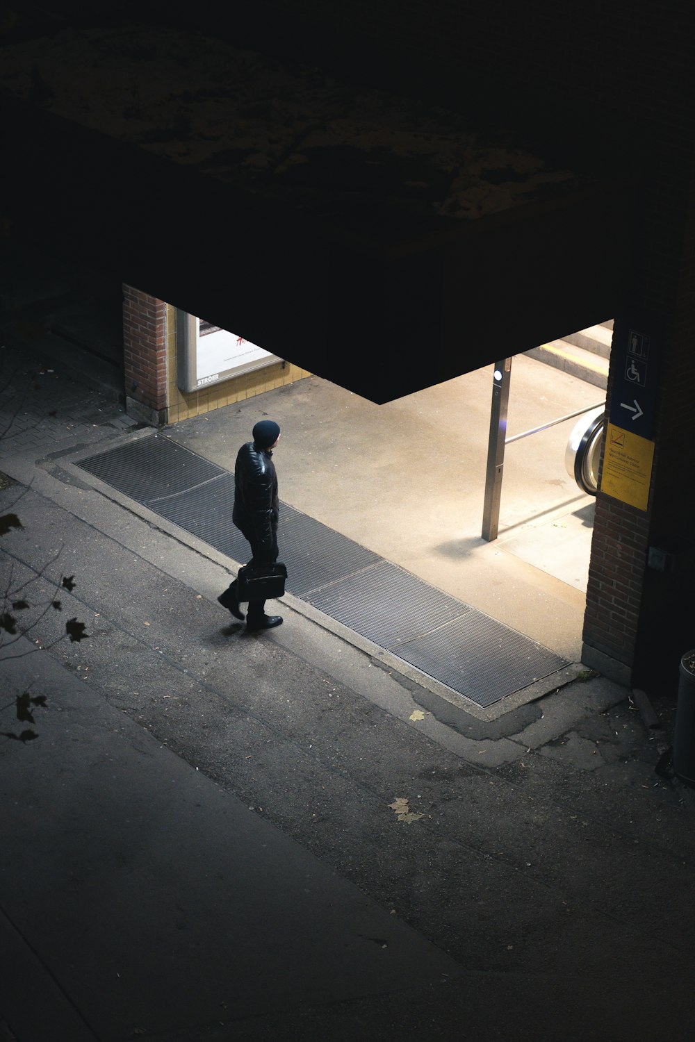 aerial photography of man about to enter a building