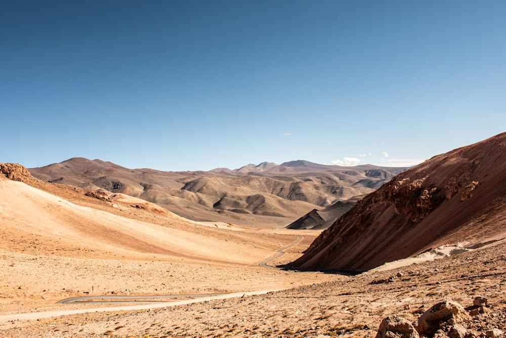 aerial photography of desert under blue and white sky