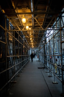 people walking on pathway showing lighted ceiling lights