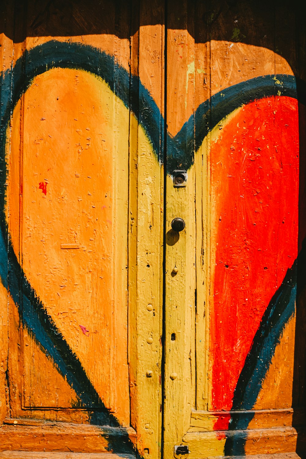 blue heart painted on a wooden panel door