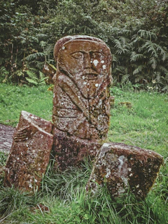 brown historic statue on green field