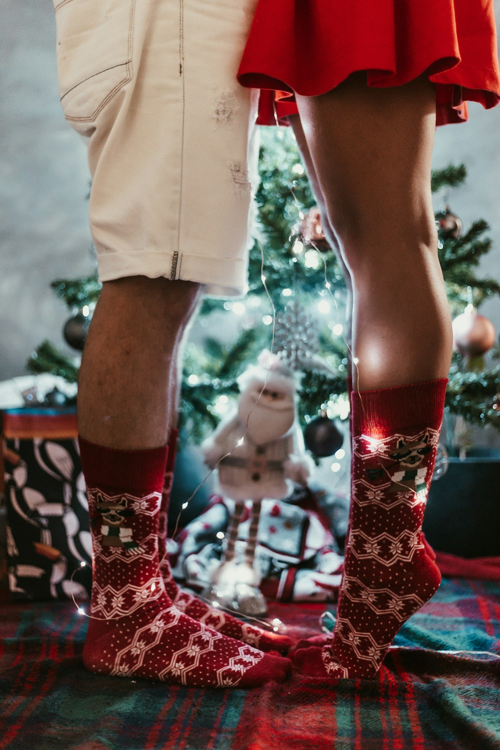 man and woman wearing red-and-white socks standing