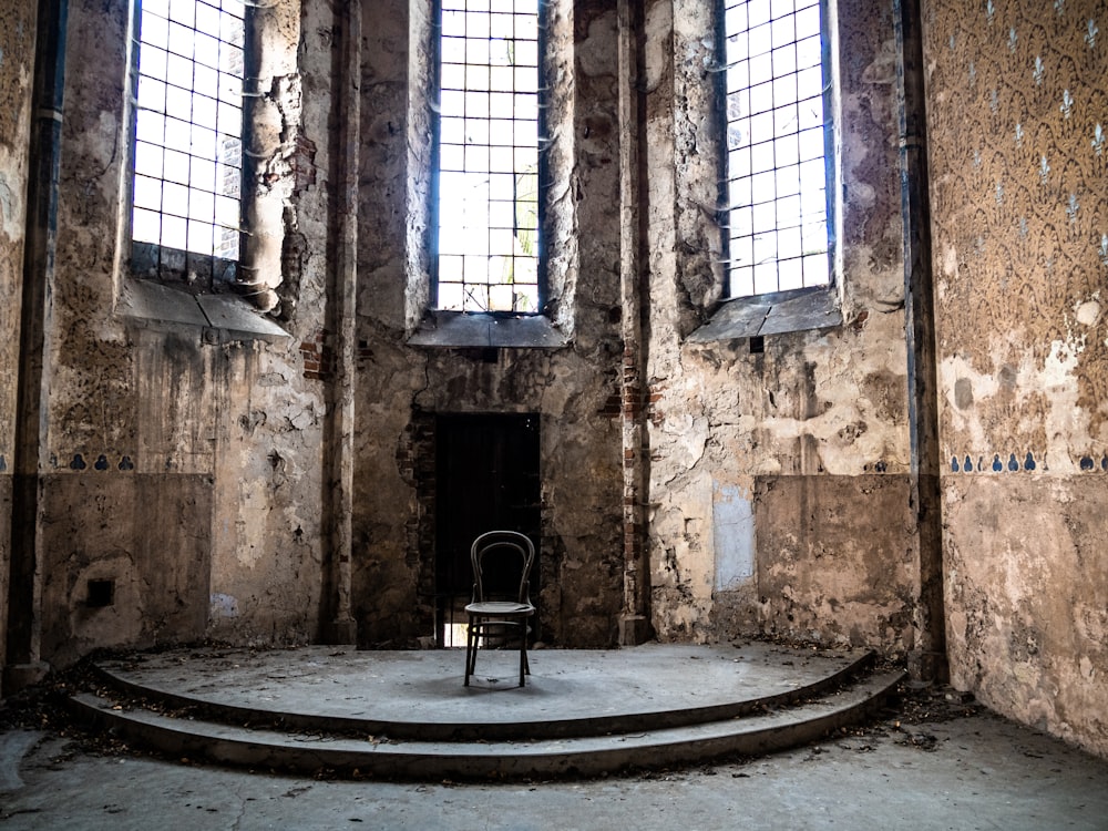 vacant black armless chair inside building