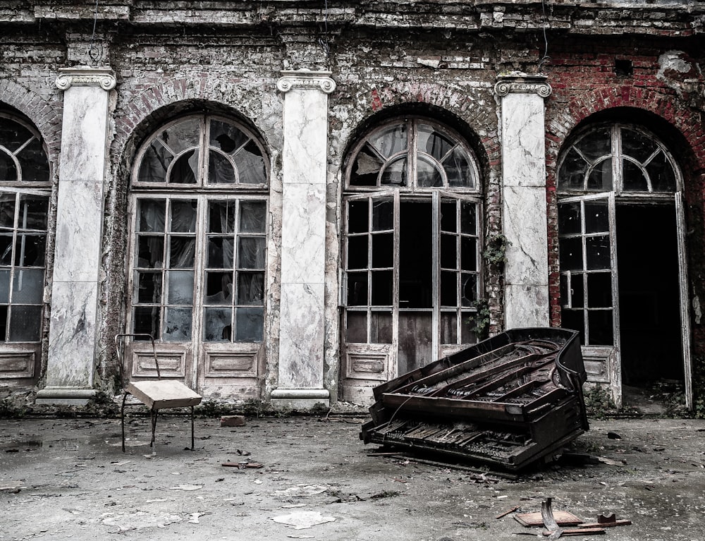 wrecked piano beside building