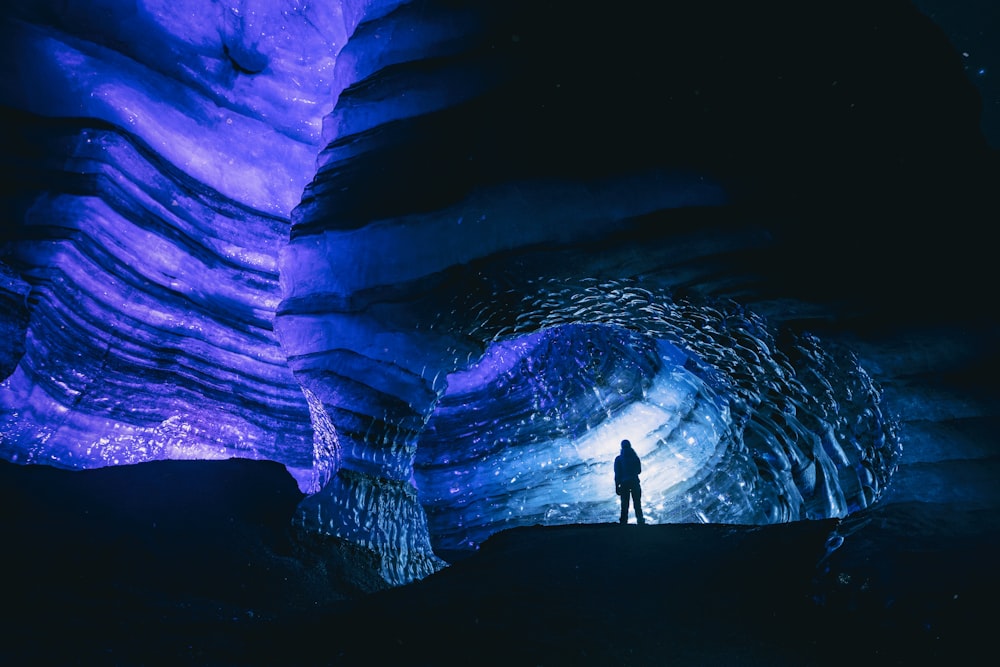 man standing inside cave