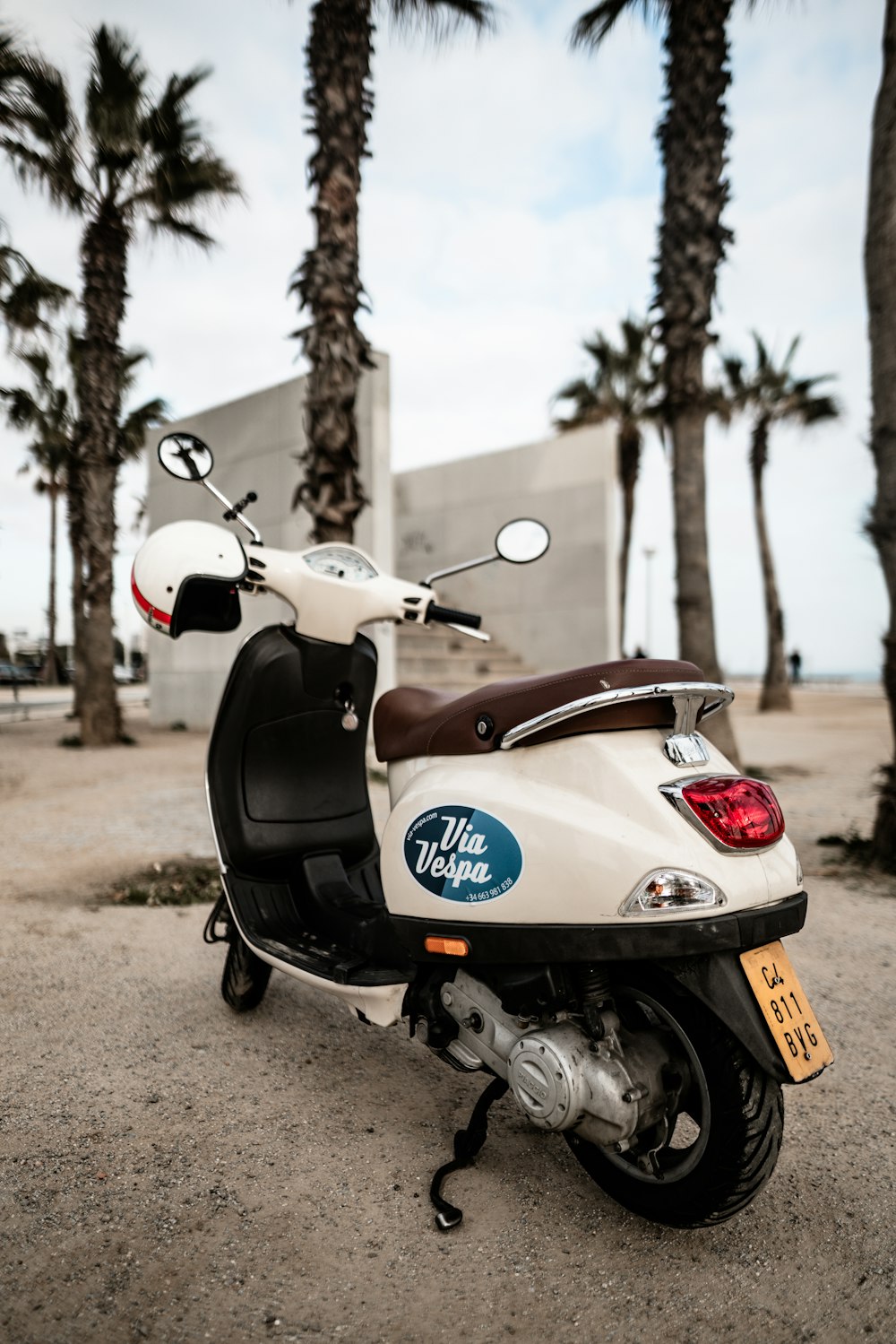 selective focus photography of parked white motor scooter beside plants