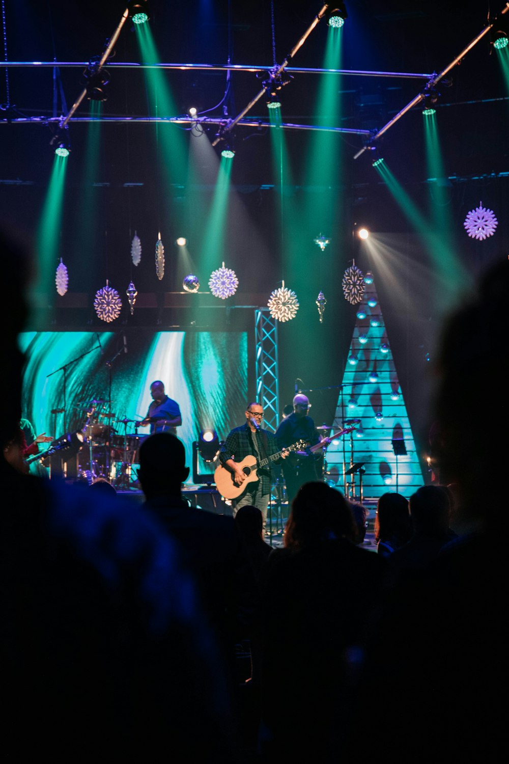 a band playing on stage with green and blue lights