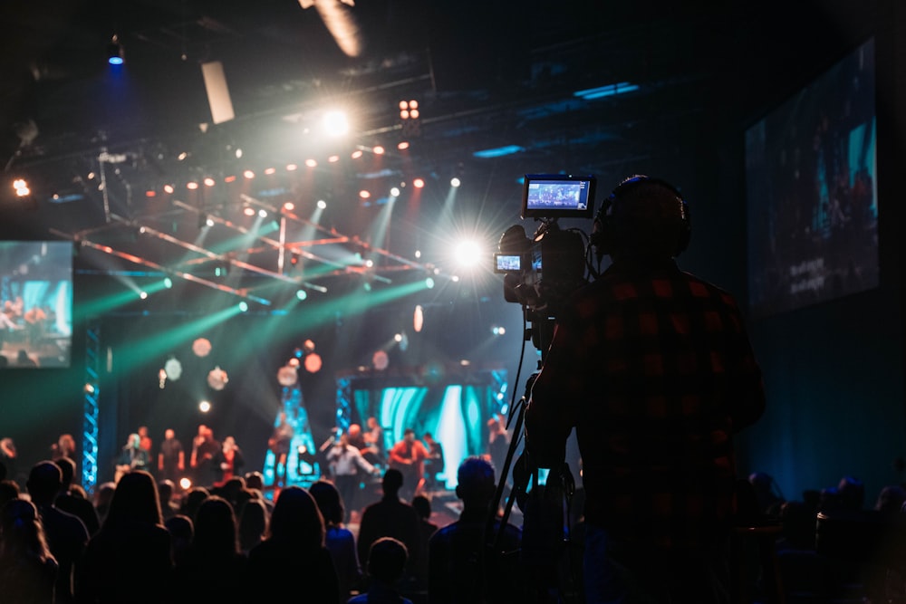 a crowd of people standing around a stage