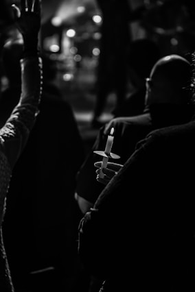 A serene candlelight vigil with people holding candles in remembrance.