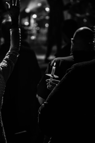 An artistic shot of a candlelit vigil held at the funérarium during evening hours.