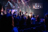 a group of people sitting on a stage in front of a crowd