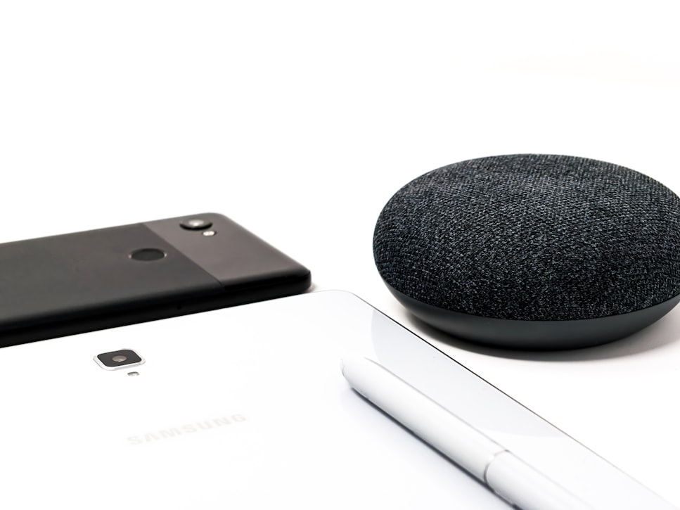 Google Nest Speaker, Google Pixel and Samsung Galaxy Note close together