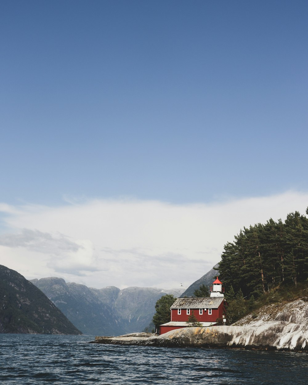 red and white house near the body of water photograph