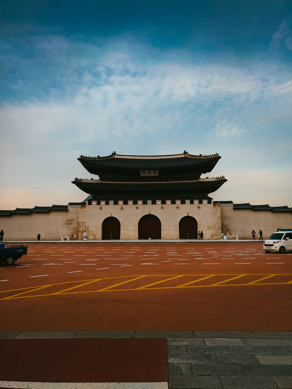 cars and people near building during day