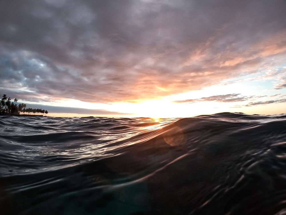 the sun is setting over a body of water