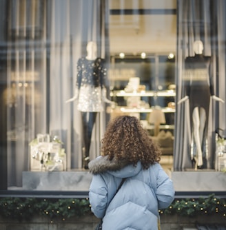 woman looking at the mannequins inside shop