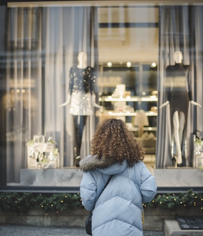 woman looking at the mannequins inside shop