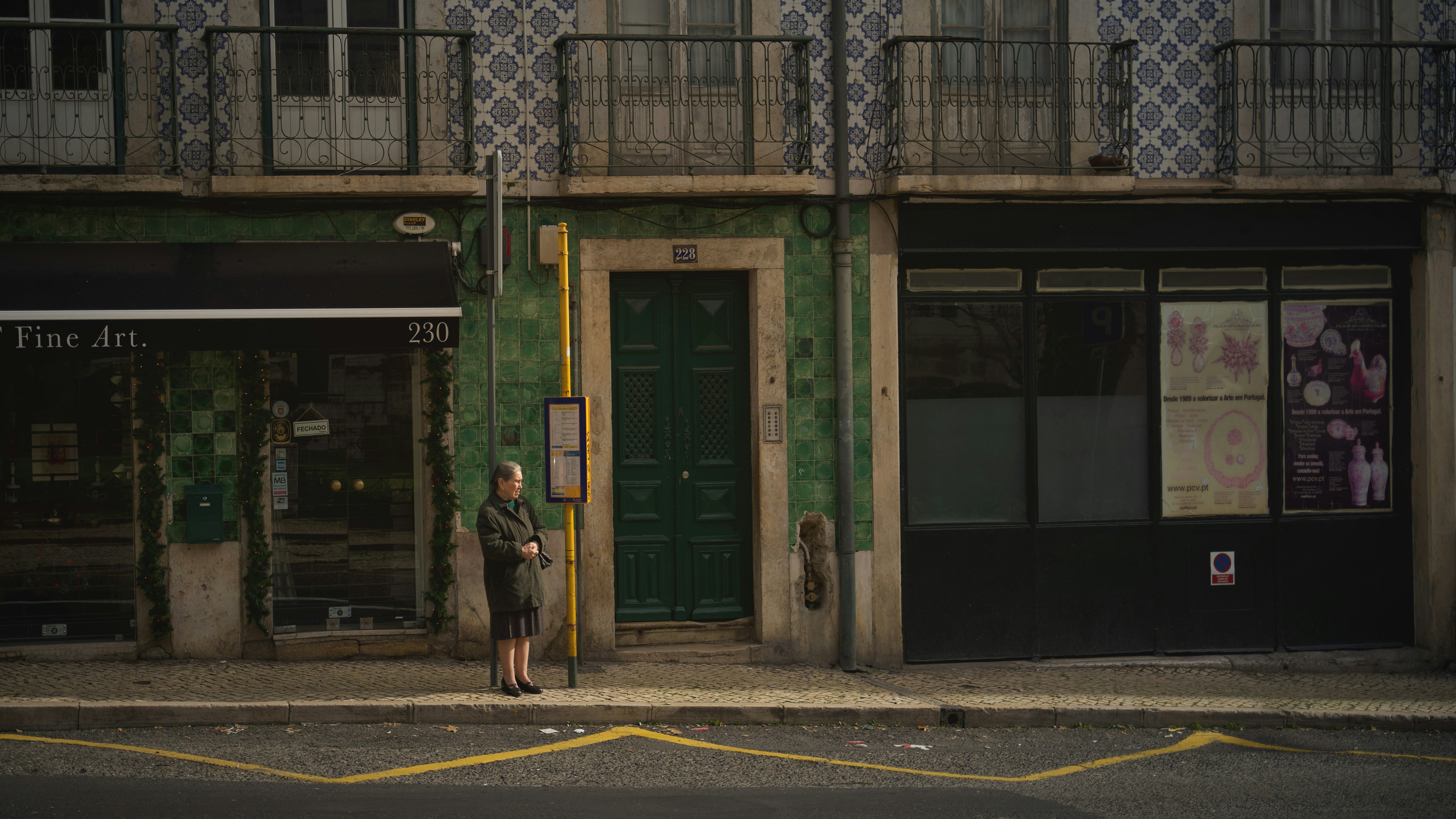 woman standing beside building during day