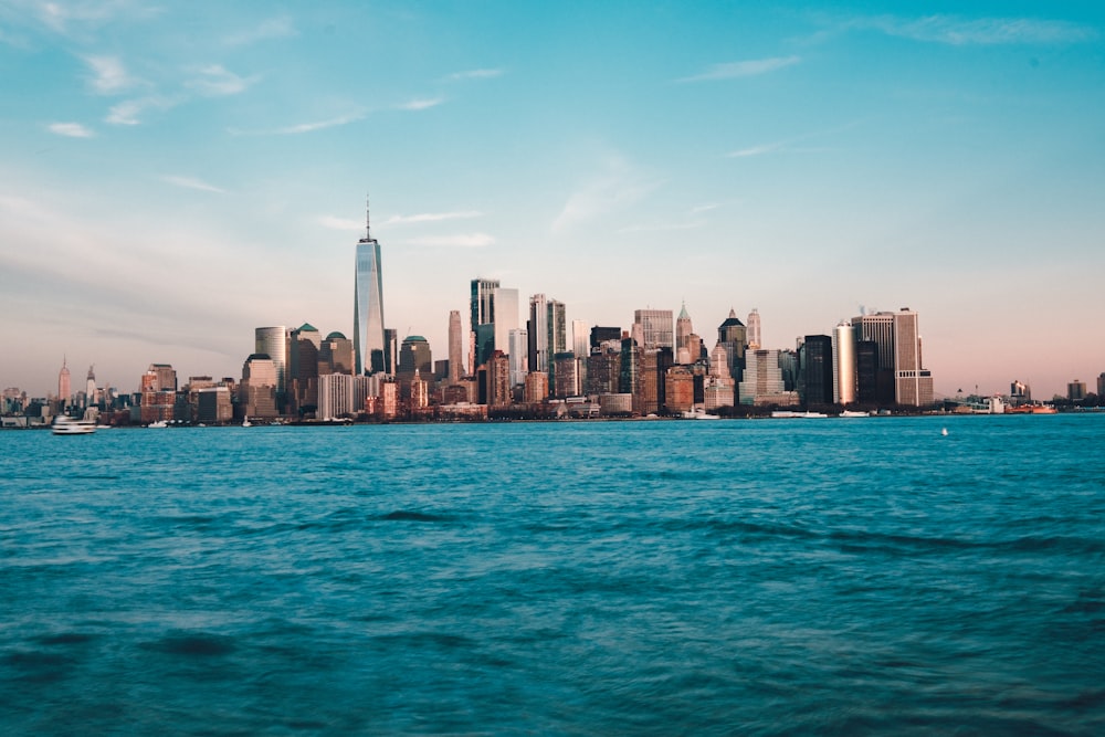 city buildings near calm body of water during daytime