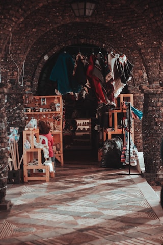 A vibrant market stall designed by Stallcraft, showcasing sleek woodwork and colorful banners under soft lighting.