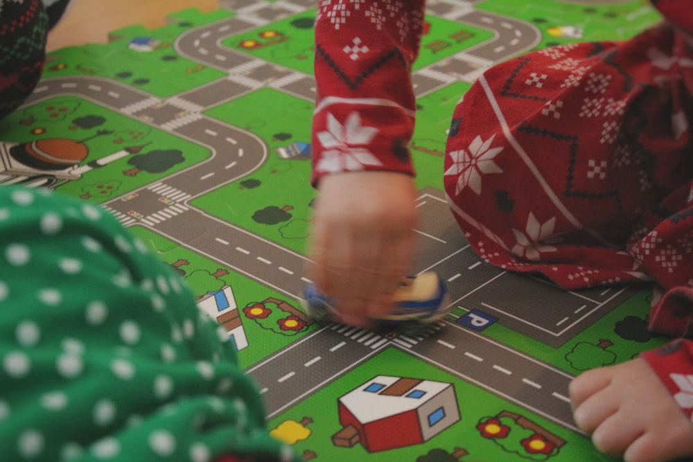 child playing on a train mat