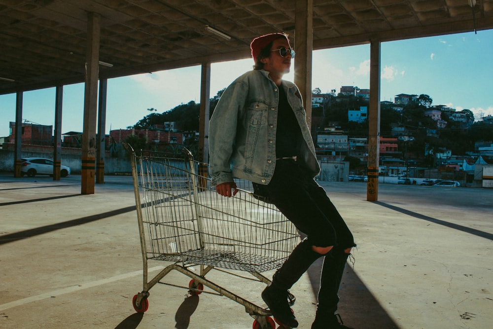 man sitting on shopping cart