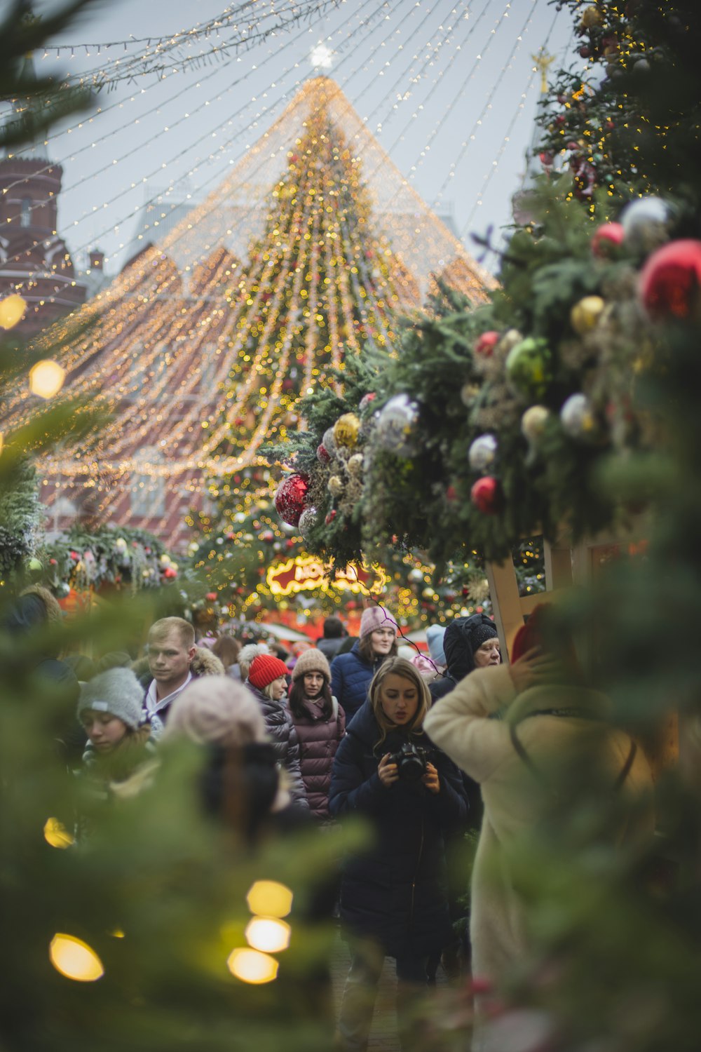 people near Christmas decors during day