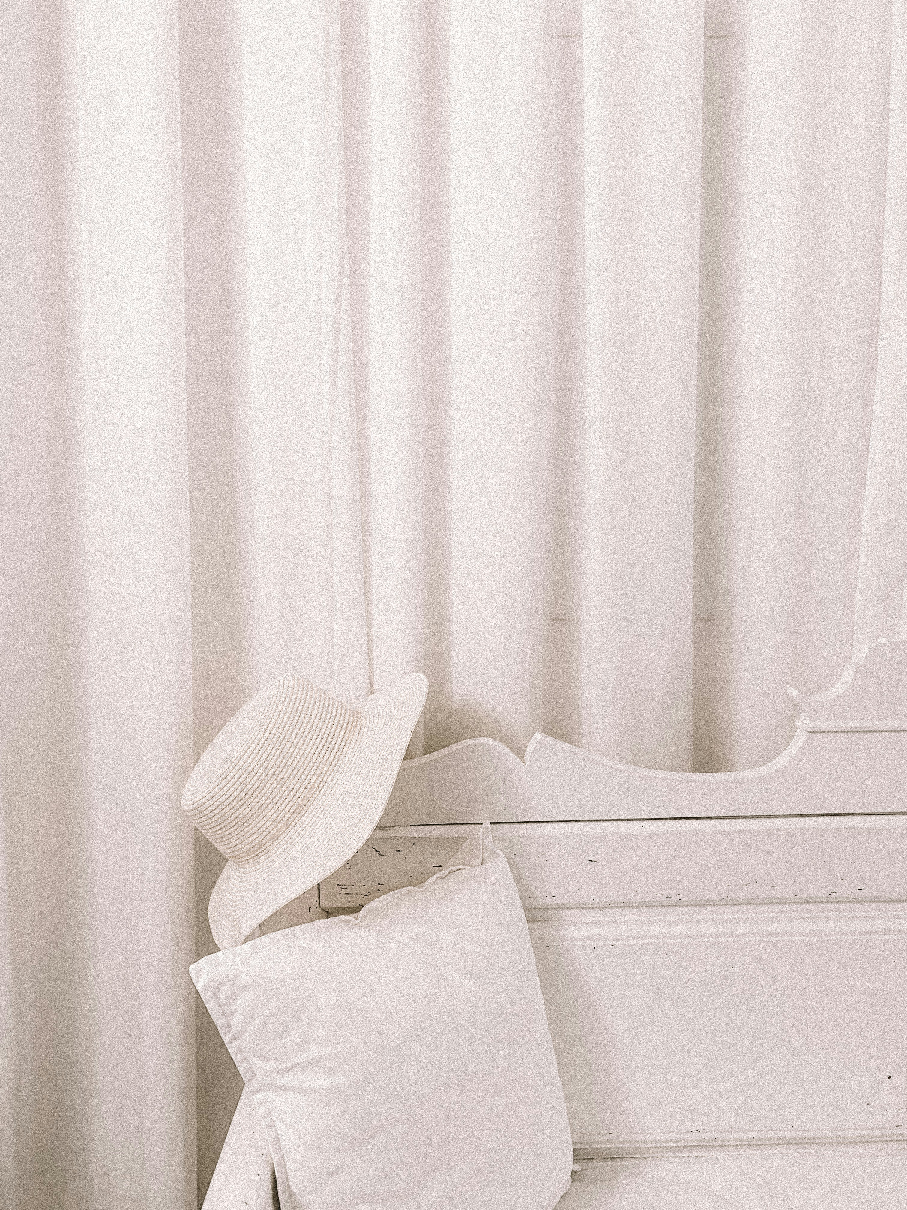 white hat on wooden bench backrest