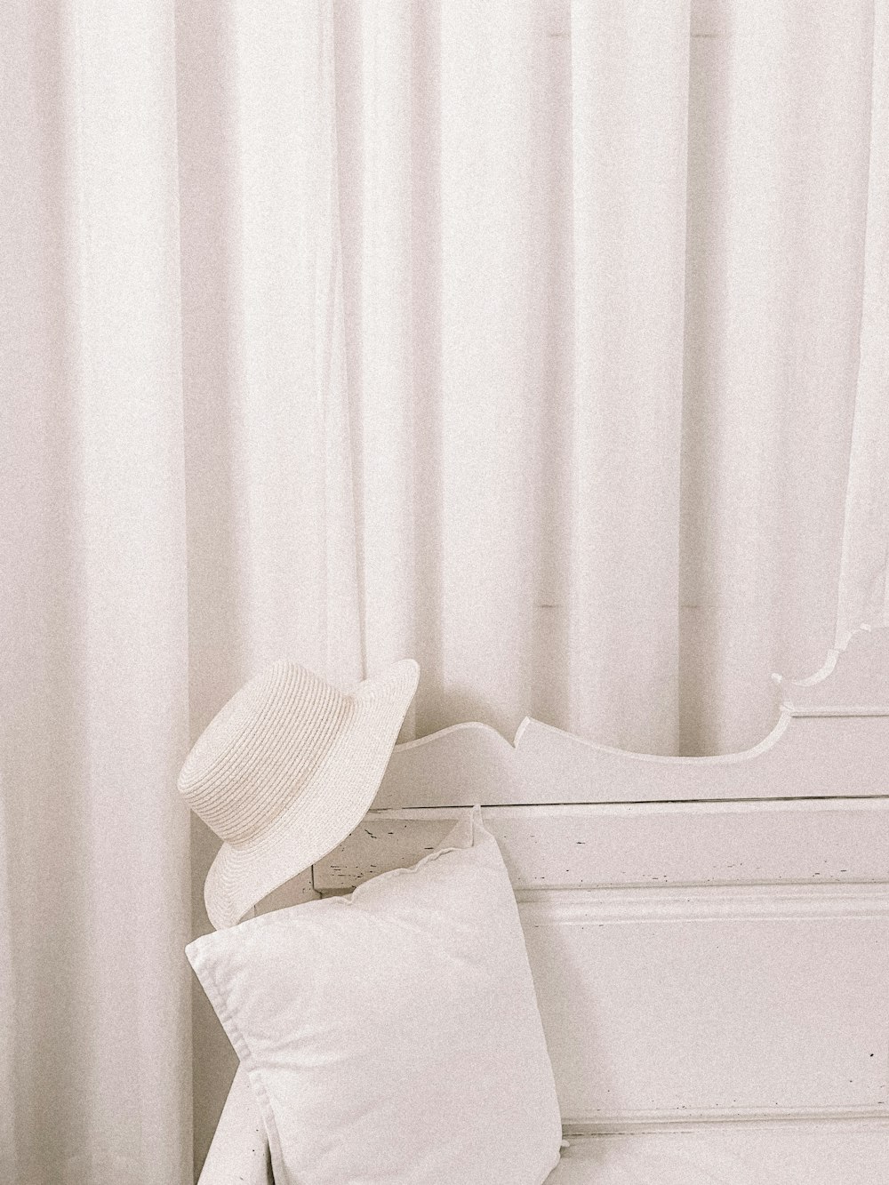 white hat on wooden bench backrest