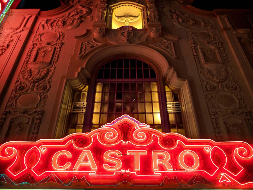 a neon sign is lit up in front of a building